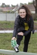 Chloe Esposito stretches before running session Image